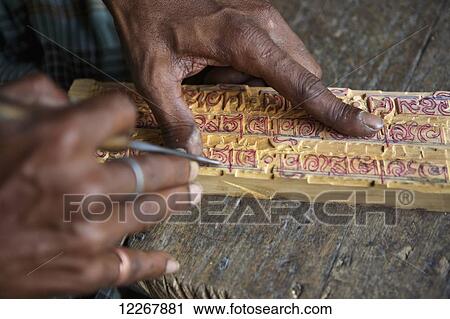 Stock Image - Man making wood carving; Kolkata, West Bengal, India. Fotosearch