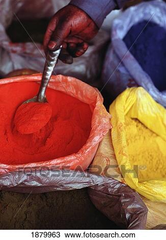 Stock Image - Man Mixing Clothes Dyes In Hotan Sunday Market. Fotosearch