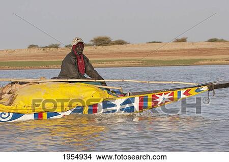 Picture - Man on a boat on the Niger River between Lake Debo and Sebi, Mali. Fotosearch