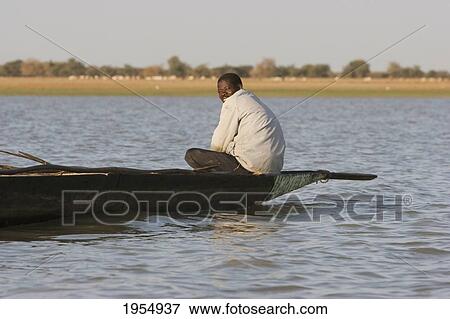 Stock Photo - Man on a boat on the Niger River between Lake Debo and Sebi, Mali. Fotosearch