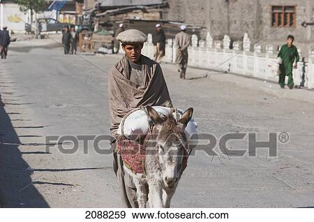 Stock Photo - Man On A Donkey, Dasu, North-West Frontier Province, Pakistan. Fotosearch