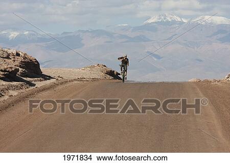 Man On A Mountain Bike Travelling Through The Valle De La Luna (Moon Valley), San Pedro De Atacama, Antofagasta Region, Chile View Large Photo Image Picture - Man On A Mountain Bike Travelling Through The Valle De La Luna (Moon Valley), San Pedro De Atacama, Antofagasta Region, Chile. Fotosearch