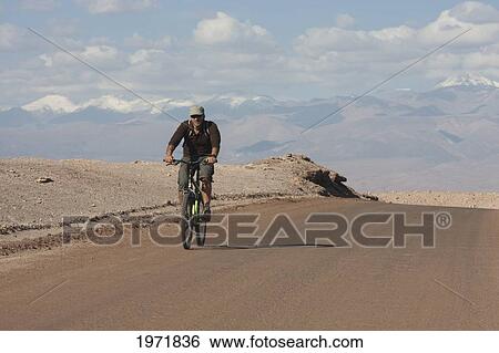 Man On A Mountain Bike Travelling Through The Valle De La Luna (Moon Valley), San Pedro De Atacama, Antofagasta Region, Chile View Large Photo Image Stock Photograph - Man On A Mountain Bike Travelling Through The Valle De La Luna (Moon Valley), San Pedro De Atacama, Antofagasta Region, Chile. Fotosearch