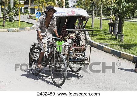 Stock Photo - Man on a rickshaw, Medan, North Sumatra, Indonesia. Fotosearch