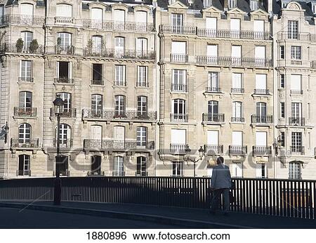 Stock Photograph - Man On Bridge To Ille De La Cite. Fotosearch