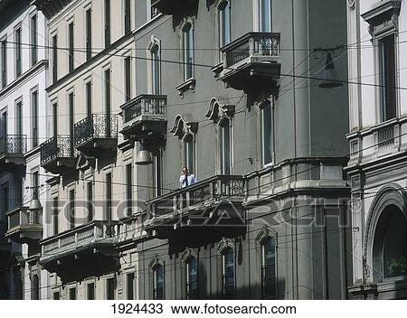 Stock Image - Man On Mobile Phone On Balcony Of Office. Fotosearch
