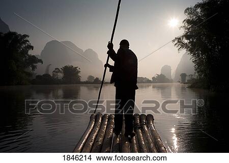 Picture - Man On Raft In Mountain Area; Yulong River, Yangshuo, China. Fotosearch