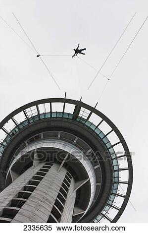 Man On Rope Jumping From Modern Tower; New Zealand View Large Photo Image Stock Photography - Man On Rope Jumping From Modern Tower; New Zealand. Fotosearch