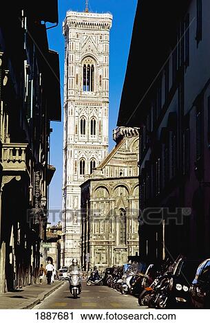 Stock Image - Man On Scooter Going Down Alley In Front Of Duomo Santa Maria Del Fiore. Fotosearch