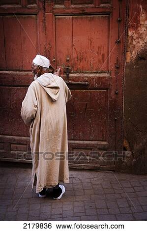 Man opening a large door in the Medina; Marrakesh, Morocco View Large Photo Image Stock Photograph - Man opening a large door in the Medina; Marrakesh, Morocco. Fotosearch