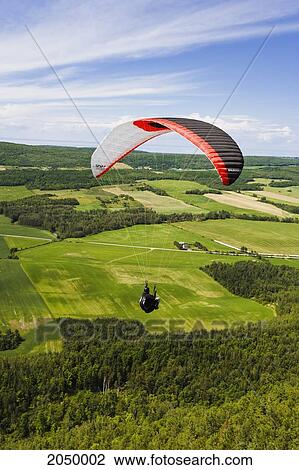 Man Paragliding Over Fields, Bas-Saint-Laurent Region, Saint-Anaclet, Quebec View Large Photo Image Stock Image - Man Paragliding Over Fields, Bas-Saint-Laurent Region, Saint-Anaclet, Quebec. Fotosearch