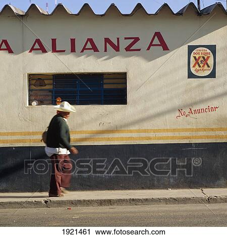 Stock Image - Man Passing Bar With Guitar. Fotosearch