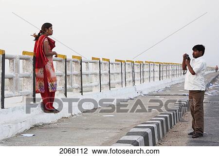 Man Photographing His Wife On The Mahatma Gandhi Seti (Bridge), Patna, Bihar, India View Large Photo Image Stock Image - Man Photographing His Wife On The Mahatma Gandhi Seti (Bridge), Patna, Bihar, India. Fotosearch