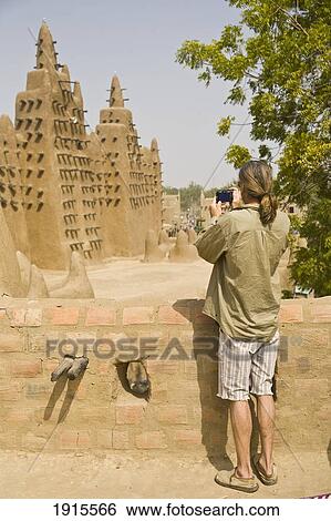 Man Photographing Mud Building Exterior View Large Photo Image Stock Photograph - Man Photographing Mud Building Exterior. Fotosearch