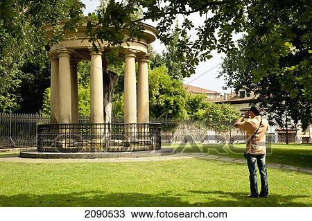Stock Image - Man Photographing The Tree Of Guernica And Casa De Juntas Beside Church Of Santa Clara, Gernika-Lumo, Basque Country, Spain. Fotosearch