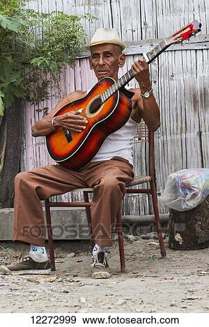 Stock Photo - Man playing a guitar, San Jacinto de Yaguachi, Guayas, Ecuador. Fotosearch