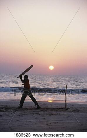 Man Playing Cricket On The Beach At Sunset View Large Photo Image Stock Image - Man Playing Cricket On The Beach At Sunset. Fotosearch