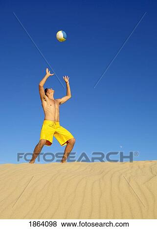 Stock Photo - Man Playing On The Beach. Fotosearch