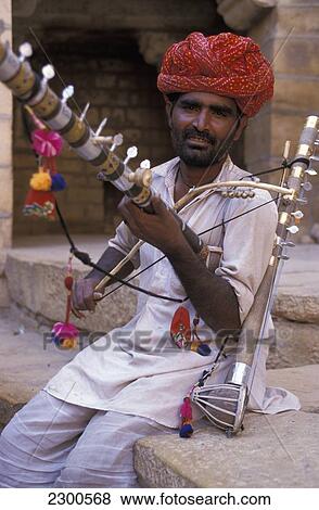 Stock Photo - Man Playing Traditional Indian Instrument, Jaisalmer, Rajasthan, India. Fotosearch