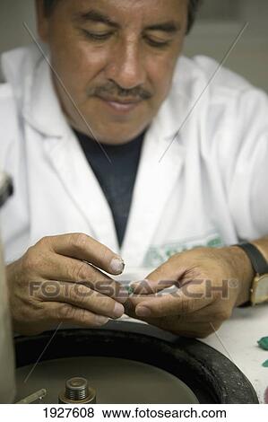 Stock Photo - Man Polishing Emeralds. Fotosearch