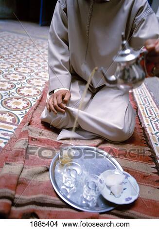Picture - Man Pouring Tea, Close Up. Fotosearch