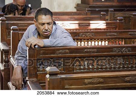 Man Praying In The Church Of The Virgin Mary Or Hanging Church, Cairo, Al Qahirah, Egypt View Large Photo Image Picture - Man Praying In The Church Of The Virgin Mary Or Hanging Church, Cairo, Al Qahirah, Egypt. Fotosearch