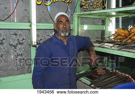 Stock Photograph - Man Preparing Kebabs At A Kabul Restaurant,, Afghanistan. Fotosearch