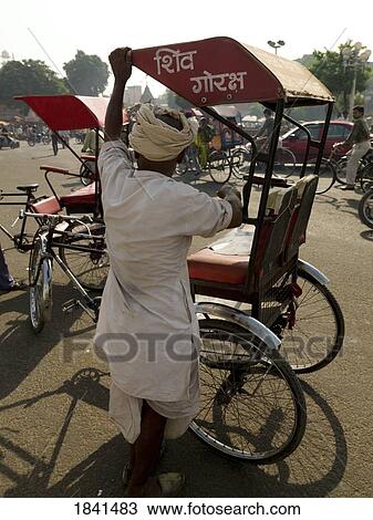 Stock Image - Man Preparing Rickshaw; Jaipur, India. Fotosearch