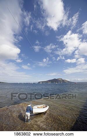 Man Putting Boat In The Water View Large Photo Image Stock Image - Man Putting Boat In The Water. Fotosearch