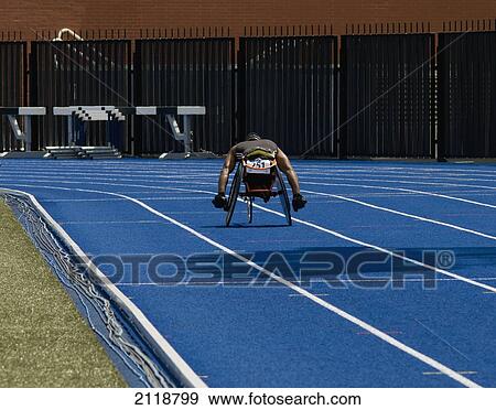 Stock Photo - Man Racing In Wheelchair On Track; Toronto Ontario Canada. Fotosearch