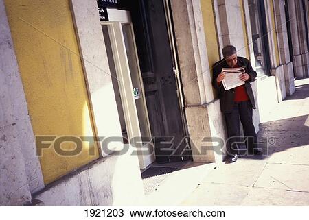 Man Reading, Leaning Against A Wall View Large Photo Image Stock Image - Man Reading, Leaning Against A Wall. Fotosearch