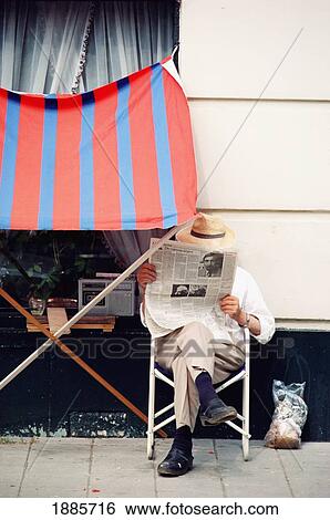 Man Reading Newspaper Beside Building View Large Photo Image Stock Photograph - Man Reading Newspaper Beside Building. Fotosearch