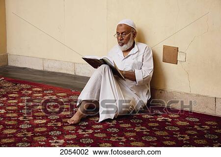 Stock Image - Man Reading The Koran In The Mosque Of Al-Aqmar, Cairo, Al Qahirah, Egypt. Fotosearch