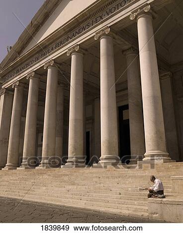 Stock Photo - Man Readning Newspaper, Stairs With Columns In Background; Naples, Italy. Fotosearch