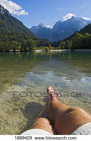 Man Relaxing At Lake Jasna. View Large Photo Image Stock Photo - Man Relaxing At Lake Jasna.. Fotosearch