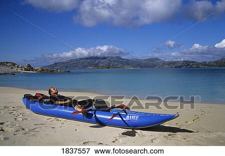 Man Relaxing In Canoe; Island Of Scarp, Island Of Harris, Scotland, Uk View Large Photo Image Stock Photo - Man Relaxing In Canoe; Island Of Scarp, Island Of Harris, Scotland, Uk. Fotosearch