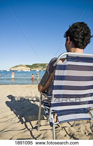 Man Relaxing In Deckchair On Beach At Cala Mongo View Large Photo Image Stock Photography - Man Relaxing In Deckchair On Beach At Cala Mongo. Fotosearch