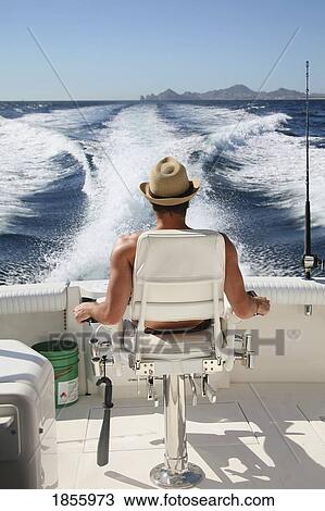 Stock Image - Man Relaxing On Boat, Cabo San Lucas, Mexico. Fotosearch