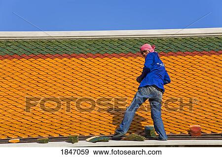 Stock Photo - Man Repairing Roof Of Wat Pho Temple In Rattanakosin District; Bangkok, Thailand. Fotosearch