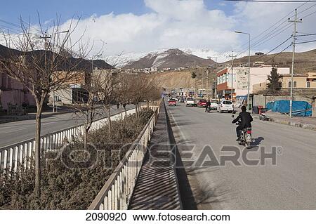 Man Riding A Bike In Town Near Iran Border, Iraqi Kurdistan, Iraq View Large Photo Image Stock Image - Man Riding A Bike In Town Near Iran Border, Iraqi Kurdistan, Iraq. Fotosearch