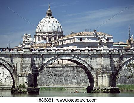 Stock Image - Man Rowing Scull Under Bridge On The River Tiber With The Dome Of St Peter's Basilica In The Background. Fotosearch