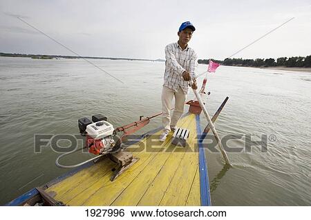 Man Sailing Fishing Boat On Mekong River, Kampi, Cambodia View Large Photo Image Stock Photograph - Man Sailing Fishing Boat On Mekong River, Kampi, Cambodia. Fotosearch