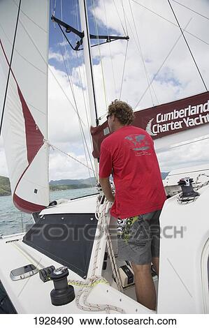 Stock Image - Man Sailing In The Whitsunday Islands, Queensland, Australia. Fotosearch