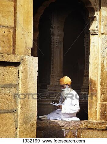 Stock Photo - Man sat outside a haveli Jaisalmer Rajasthan India. Fotosearch