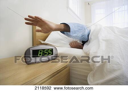 Man Shutting Off Alarm Clock; Toronto Ontario Canada View Large Photo Image Stock Image - Man Shutting Off Alarm Clock; Toronto Ontario Canada. Fotosearch
