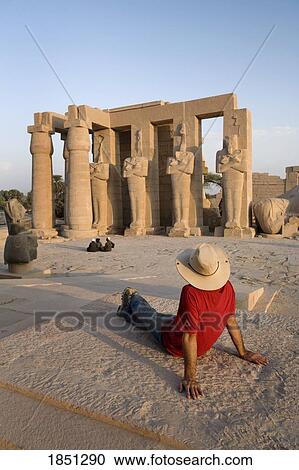 Stock Image - Man Sitting At Temple In Luxor; Cairo, Egypt, Africa. Fotosearch
