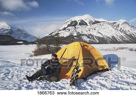 Man Sitting By His Tent In The Snow In The Winter View Large Photo Image Stock Image - Man Sitting By His Tent In The Snow In The Winter. Fotosearch