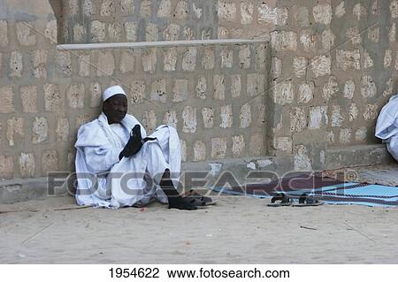 Man sitting by the Sankore Mosque, Timbuktu, Mali View Large Photo Image Stock Image - Man sitting by the Sankore Mosque, Timbuktu, Mali. Fotosearch