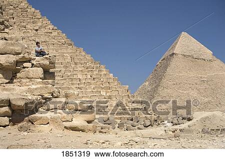 Man Sitting On Part Of A Pyramid In The Desert View Large Photo Image Stock Photo - Man Sitting On Part Of A Pyramid In The Desert. Fotosearch