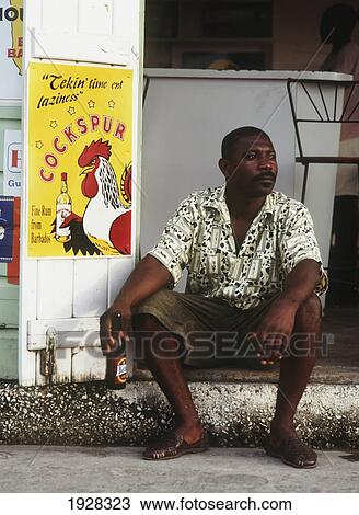 Stock Image - Man Sitting On Step With Beer. Fotosearch